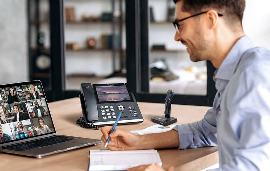 Yealink desk phone and headset on an office desk